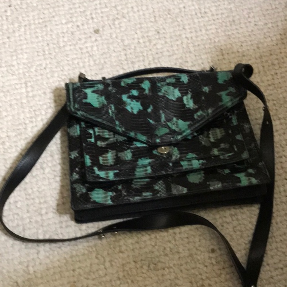 Purse by Loeffler  Randall   Has a snap closure
